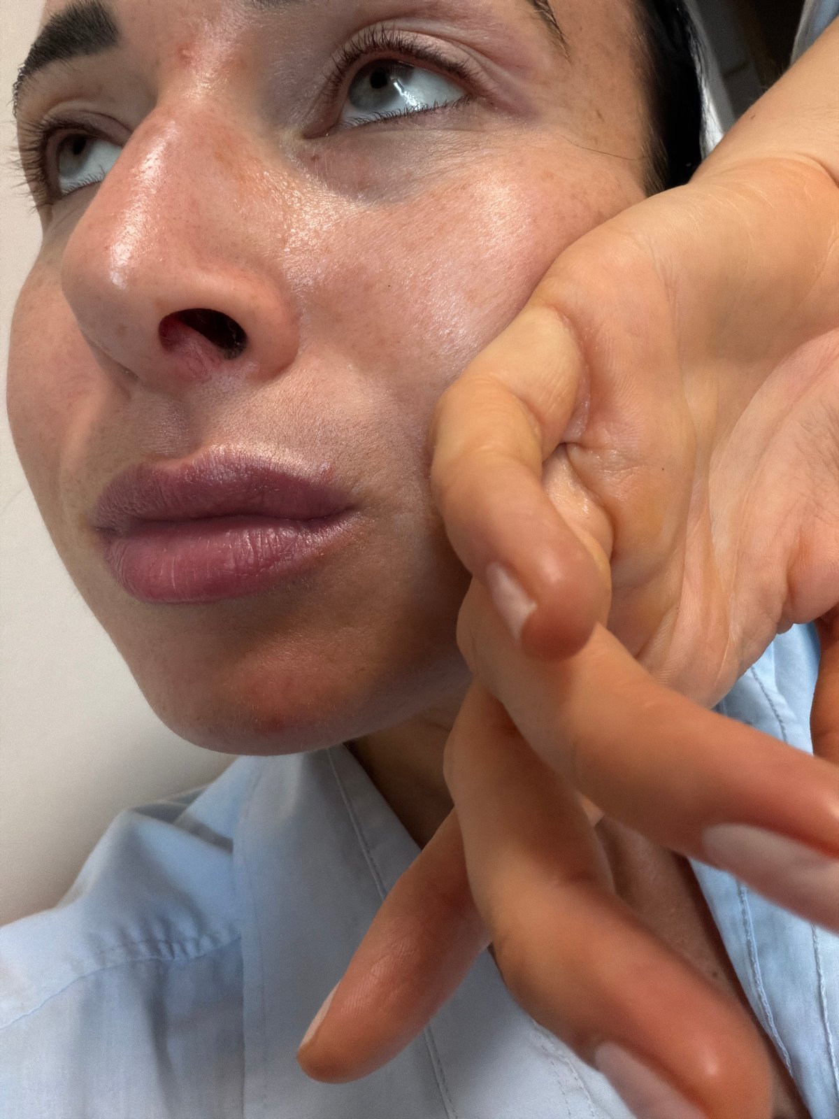 Woman applies facial treatment in Saint Petersburg afternoon