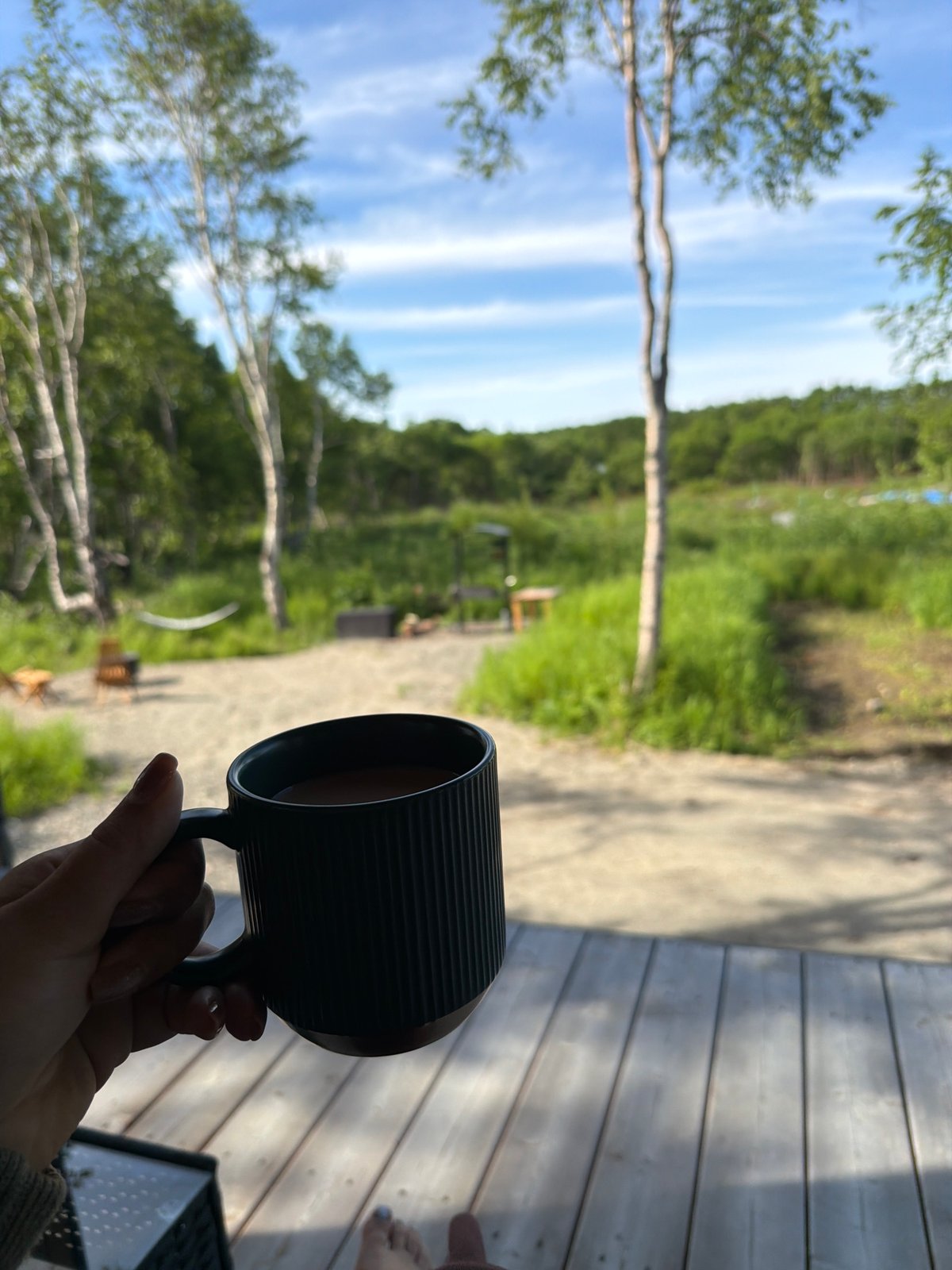 Quiet dacha morning: coffee, bare feet, and rubber boots
