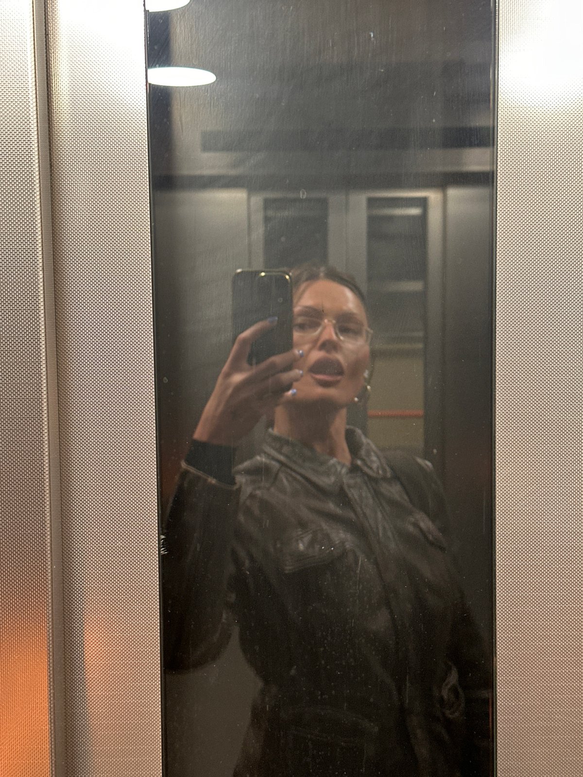 Woman takes elevator selfie in London