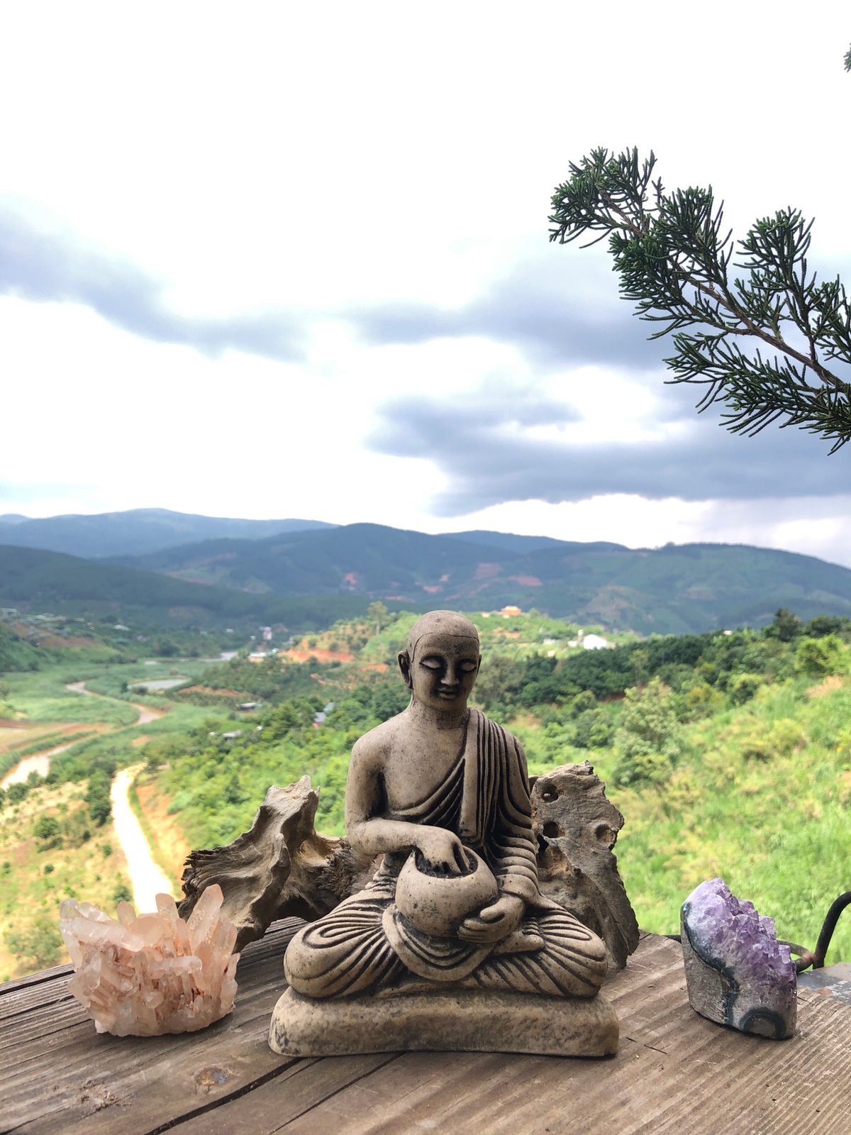 Roadside spiritual display against misty Vietnamese hills