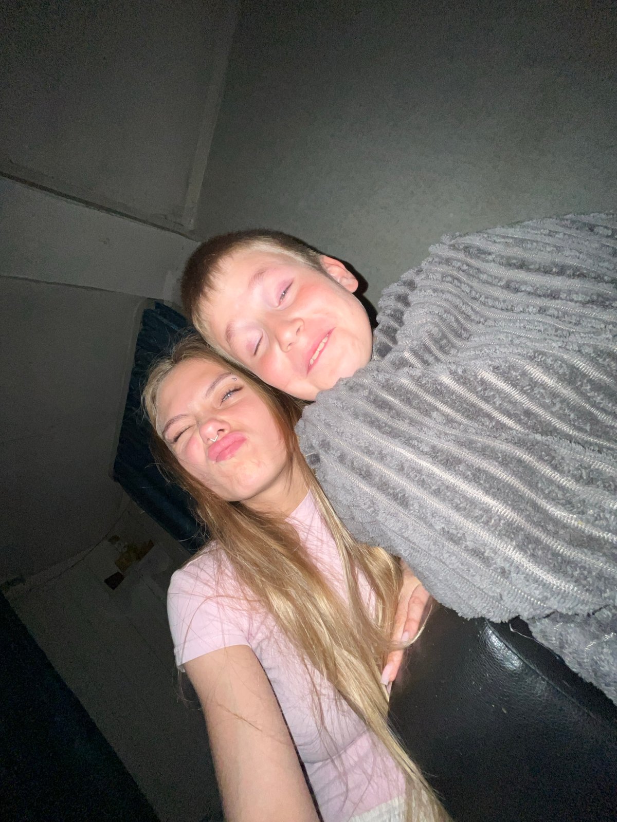 Young couple takes intimate selfie in dimly lit Russian room