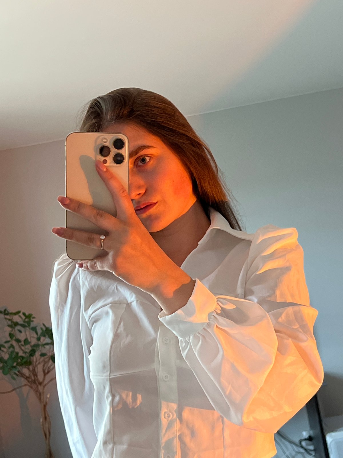 Woman takes multiple mirror selfies in white outfit in Ternopil