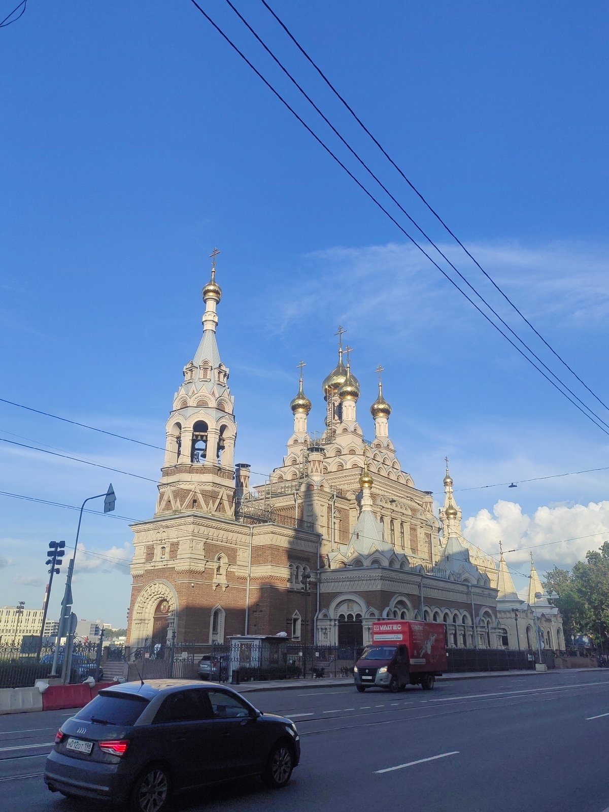 Cyclist passes golden-domed Orthodox church in Saint Petersburg