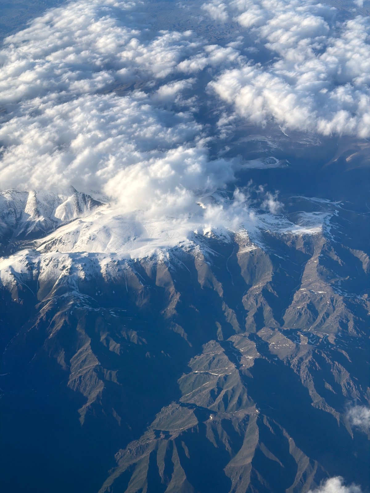 Aerial view captures snow-covered mountains near Pyatigorskoye, Kazakhstan