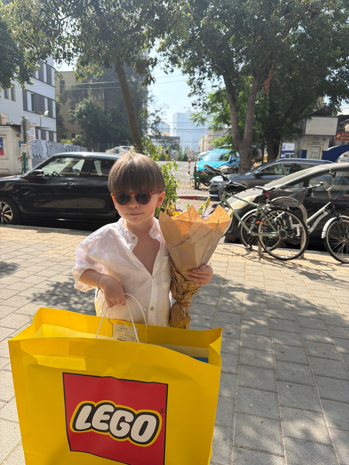 Boy with flowers spotted on Tel Aviv sidewalk Tuesday morning