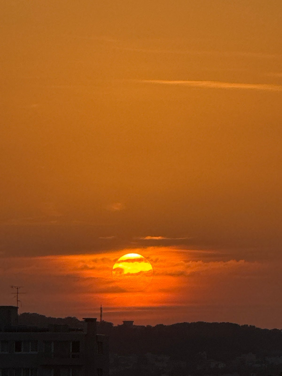 City sunset with contrails and orange skies, multiple angles