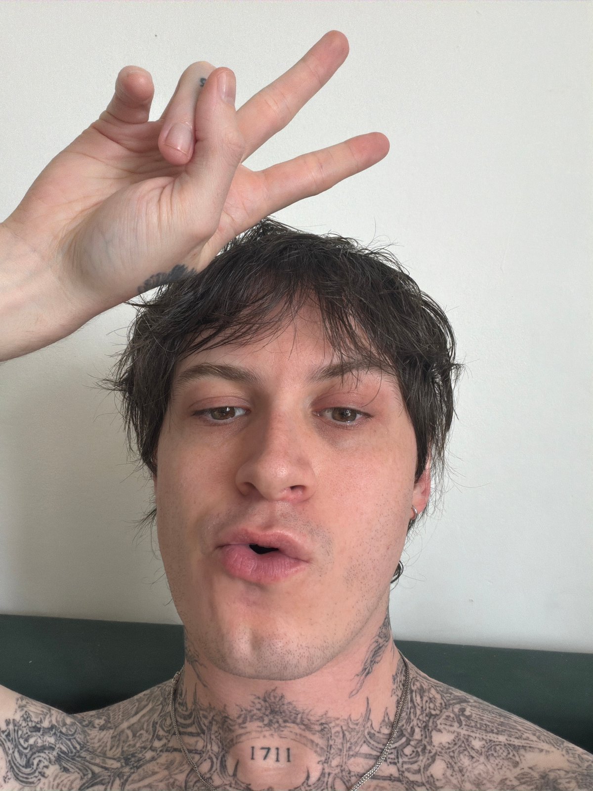 Person makes peace sign gesture captured in London