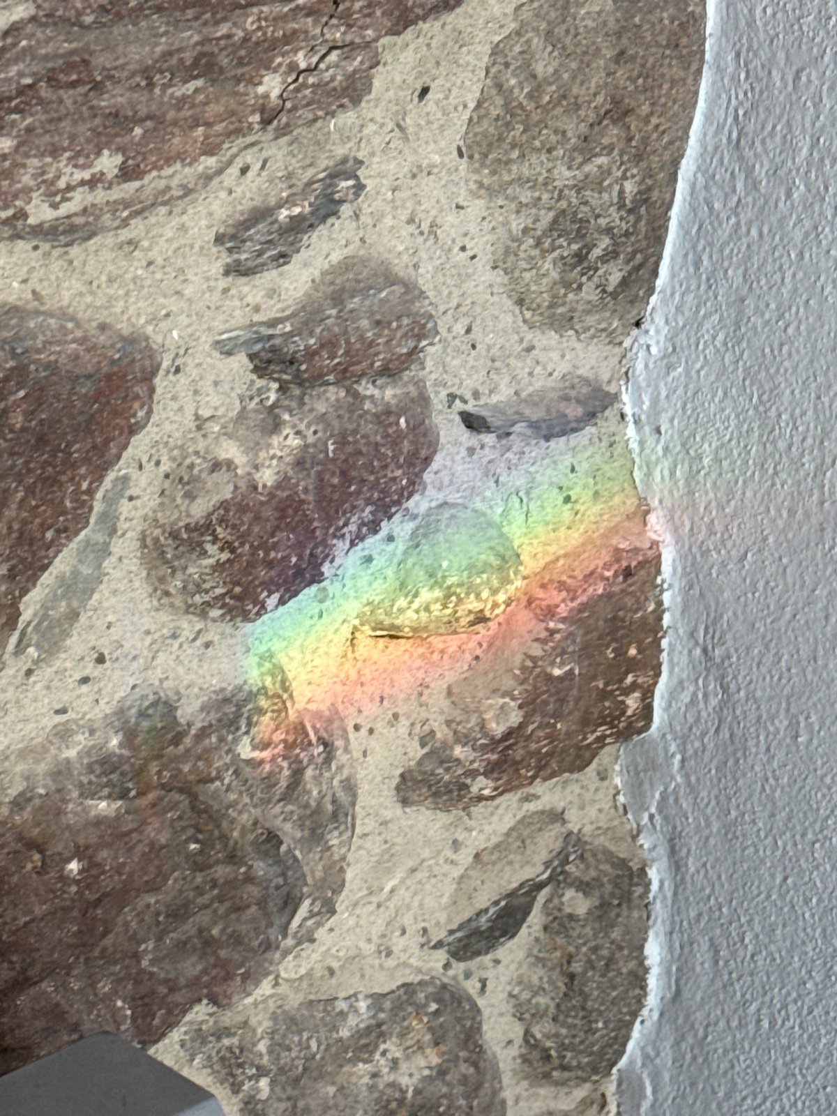 Rainbow reflections and snowy mountains observed in Benasque