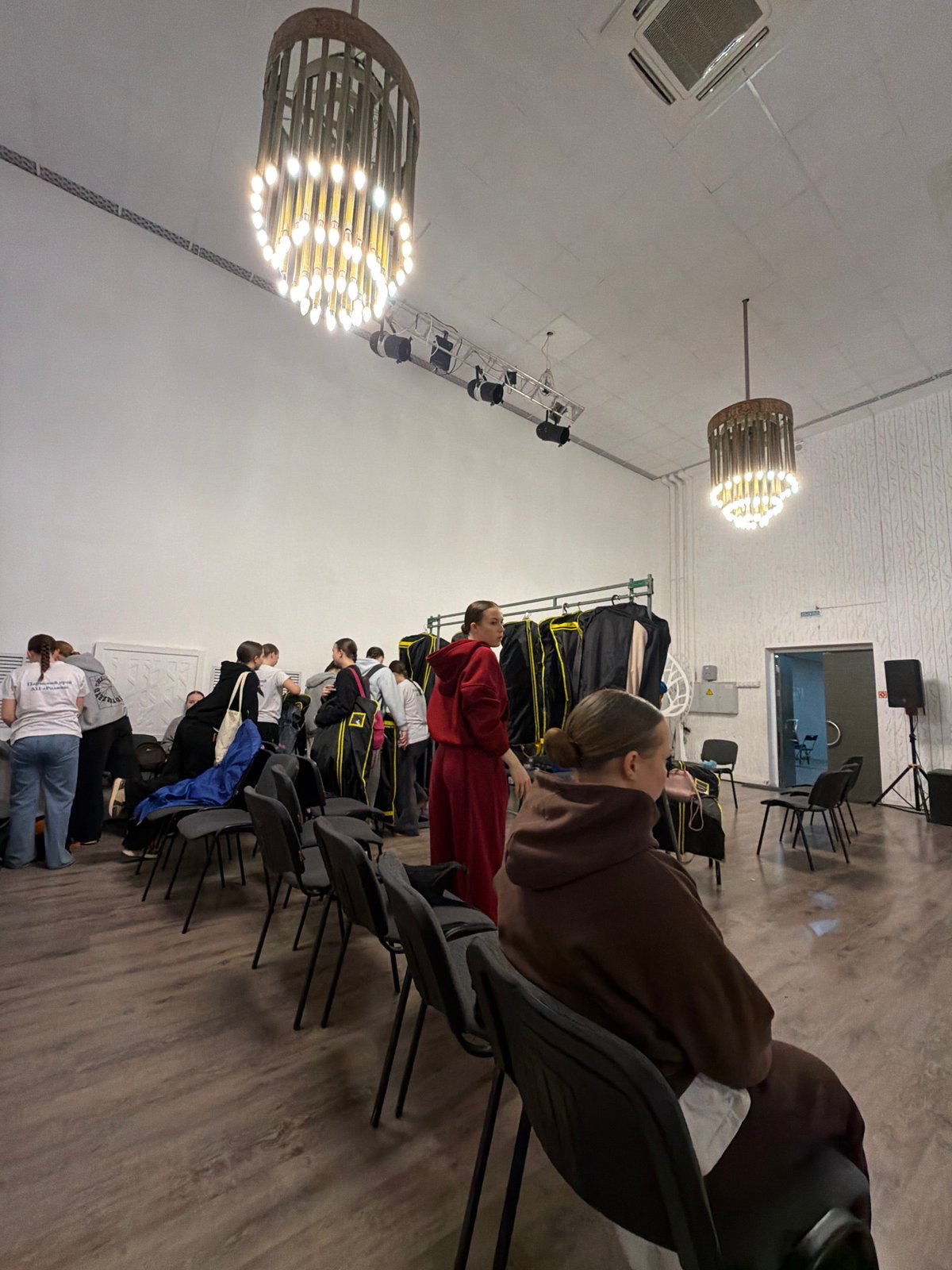 Indoor gathering documented in Perm auditorium with staged lighting