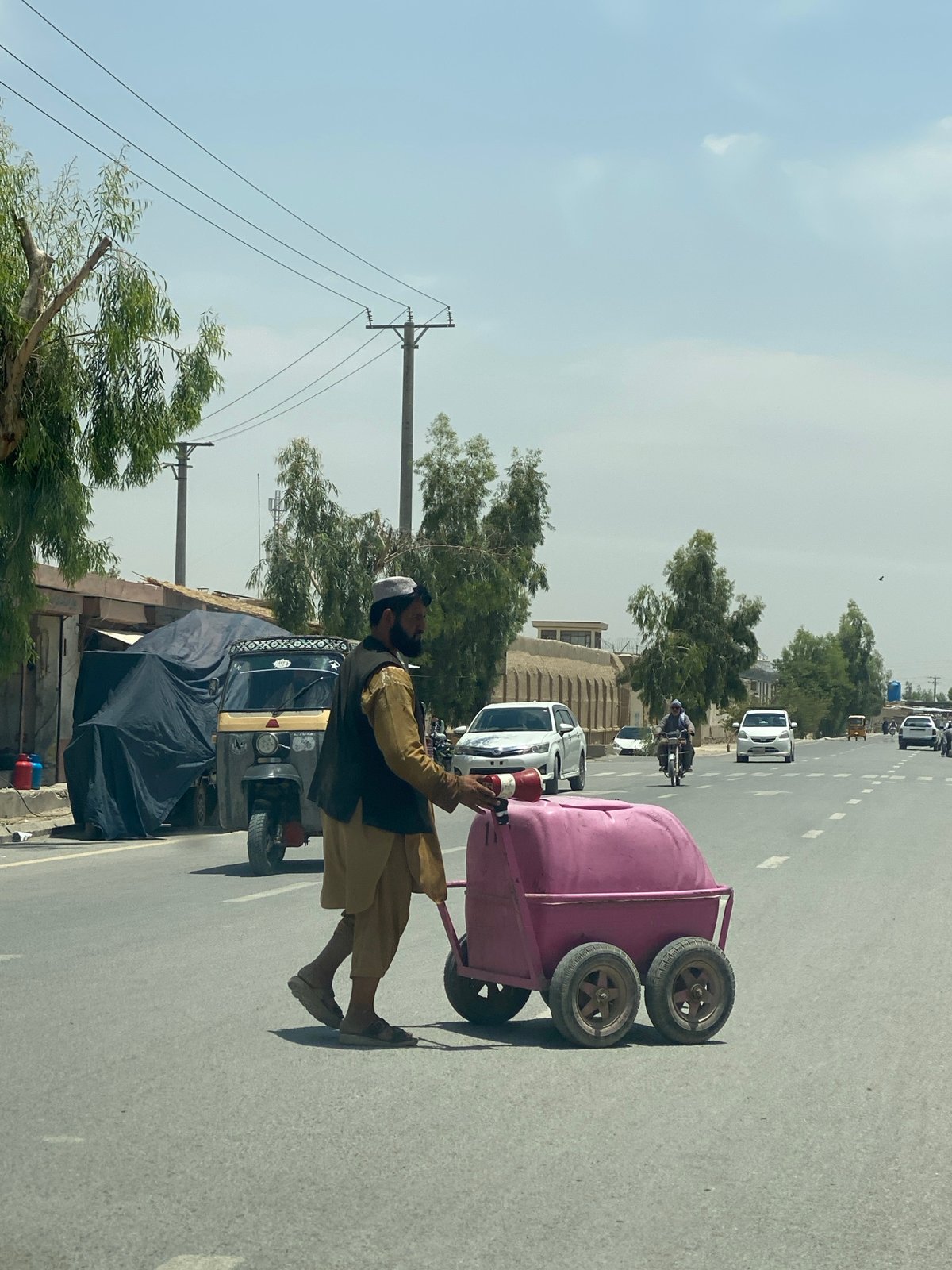 Pink barrel cart rolling through Kandahar streets