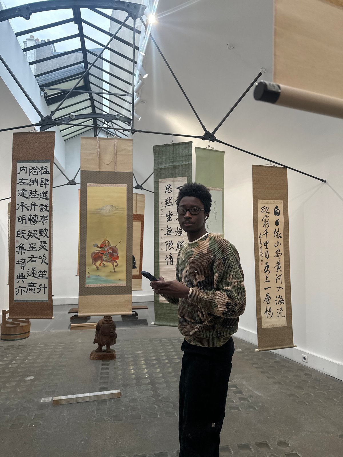 Visitors explore Asian art exhibition in Paris gallery