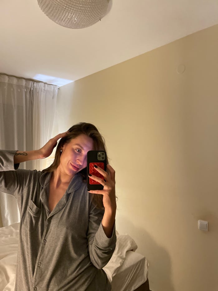 Evening skincare and pet bonding session in Budva bedroom