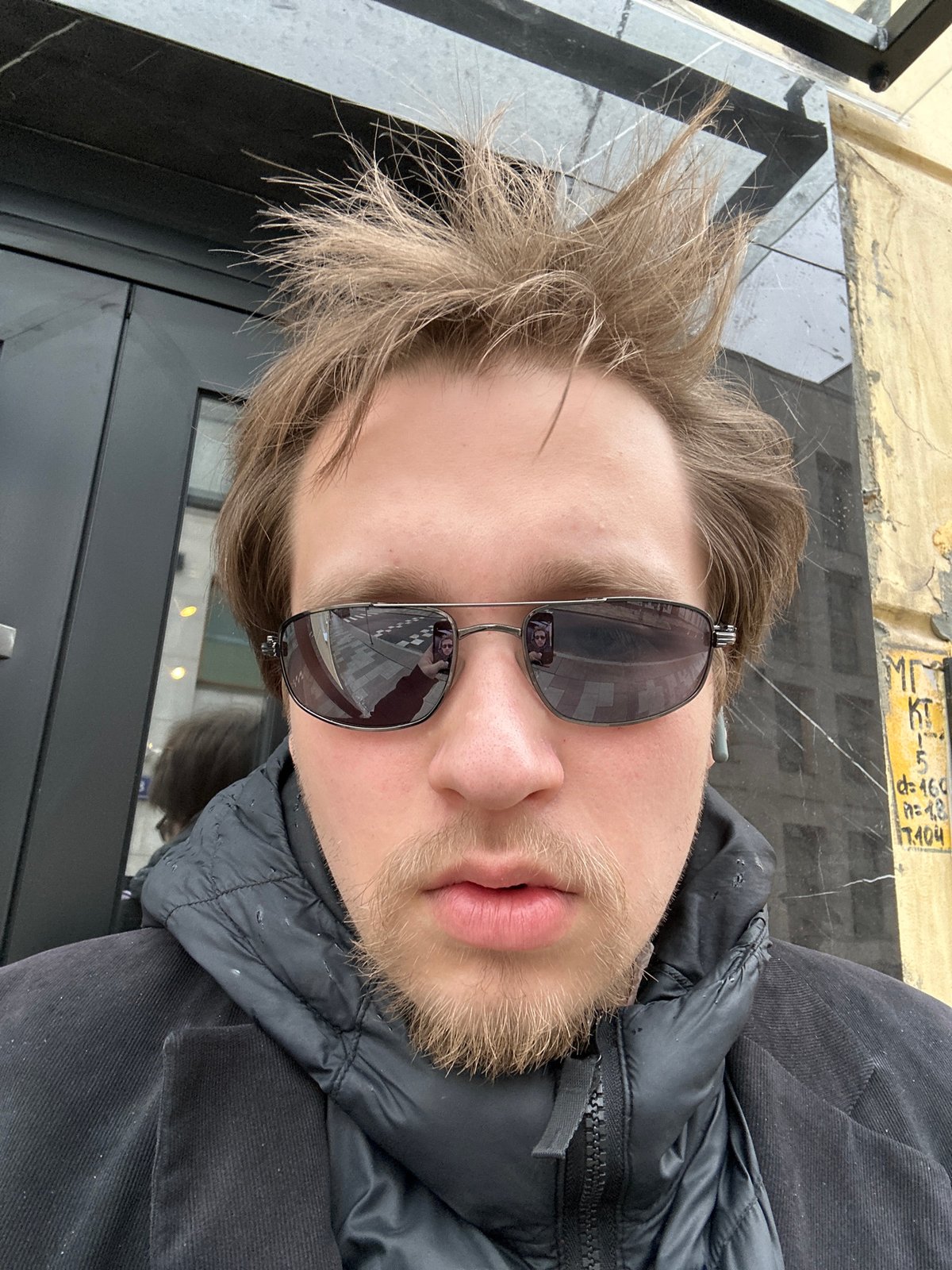 Person takes selfies near coffee shop Tuesday morning