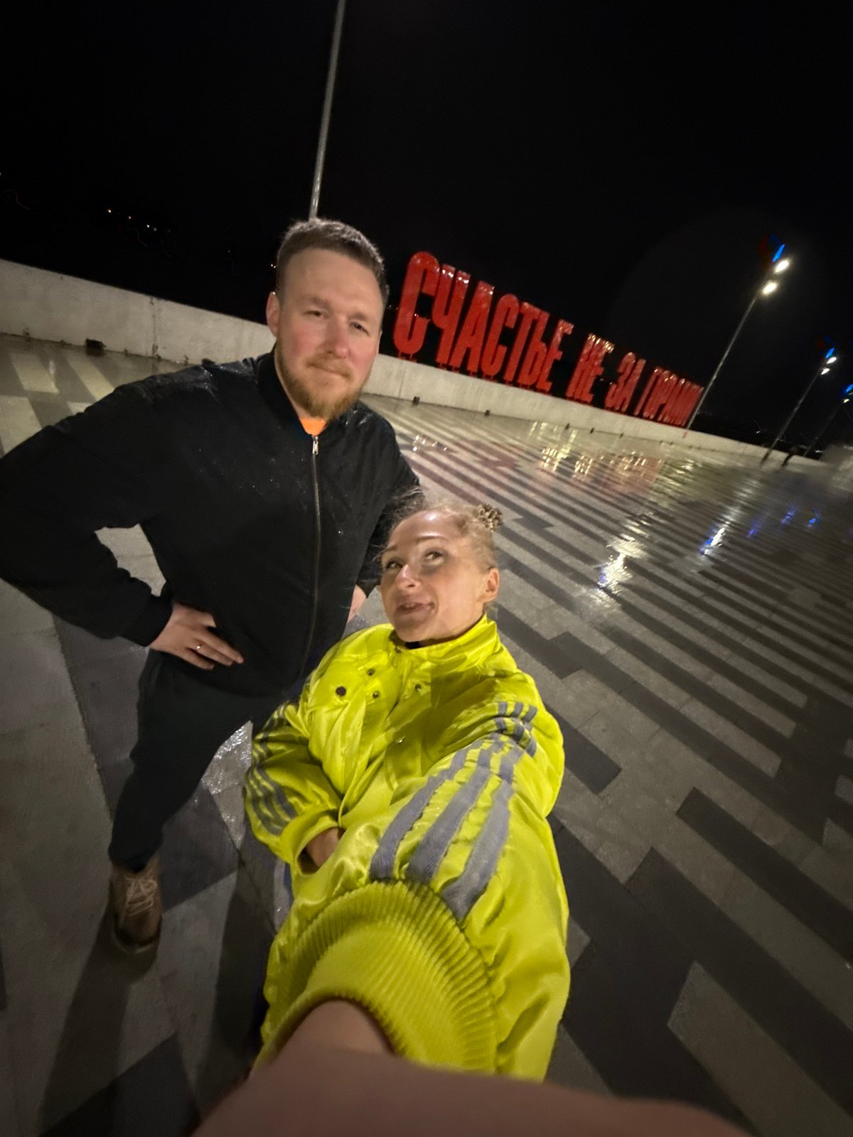 Nighttime photo session captures yellow-jacketed visitor touring central Perm landmarks