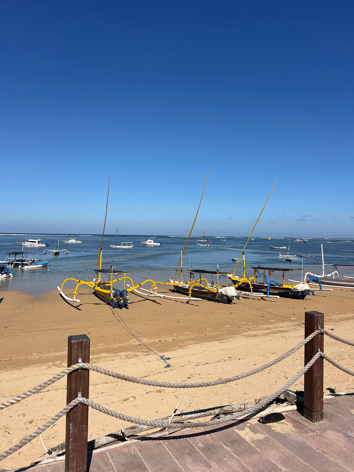 Sanur Beach at sunrise, jukung boats and Agung on the horizon