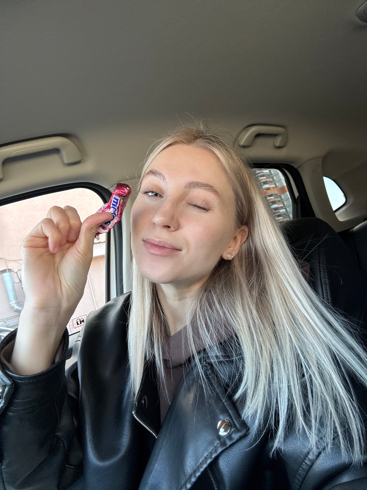 Woman takes selfies with candy in car in Izhevsk