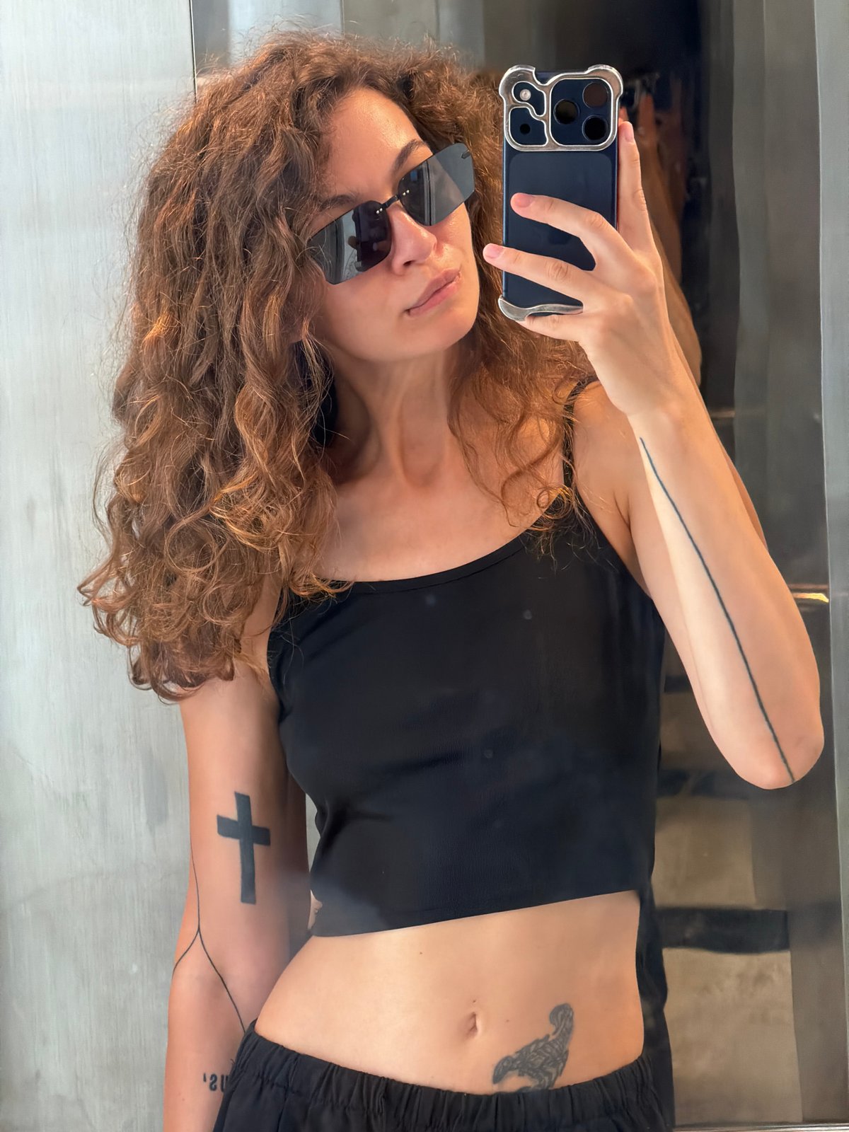 Woman takes selfie in front of reflective surface in Đà Nẵng