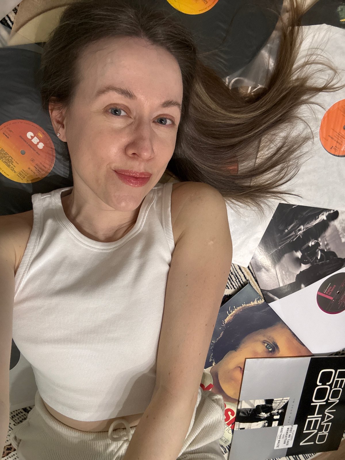 Woman poses with vinyl records in Kudrovo music photo session