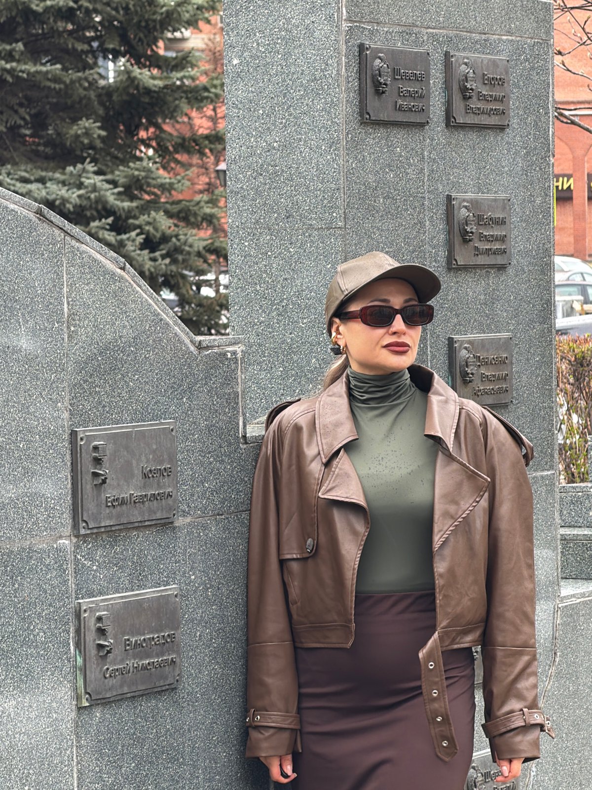 Woman visits memorial monument in rainy Krasnoyarsk morning
