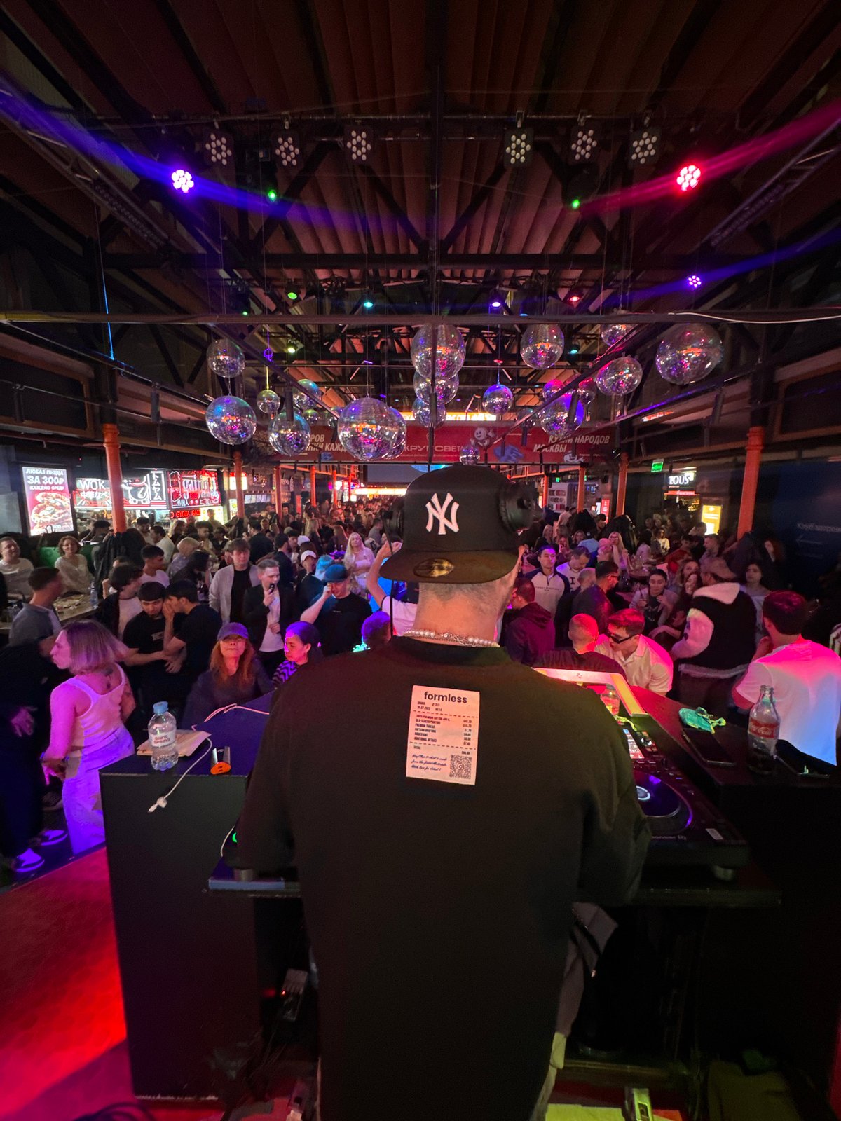 Moscow venue hosts crowded nighttime gathering with disco lighting