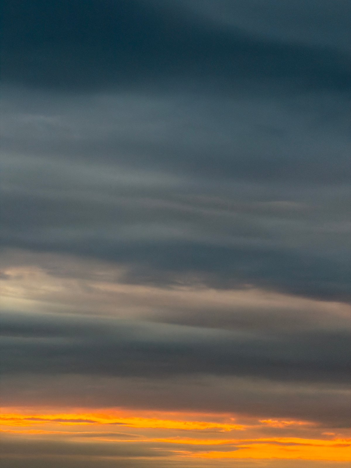 Orange-illuminated clouds observed during dawn or dusk hours