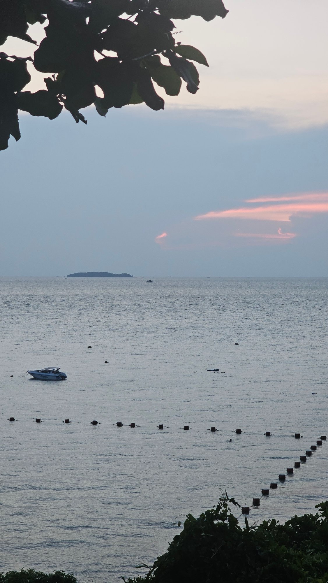 Tourist documents sunset dining experience in Pattaya, Thailand