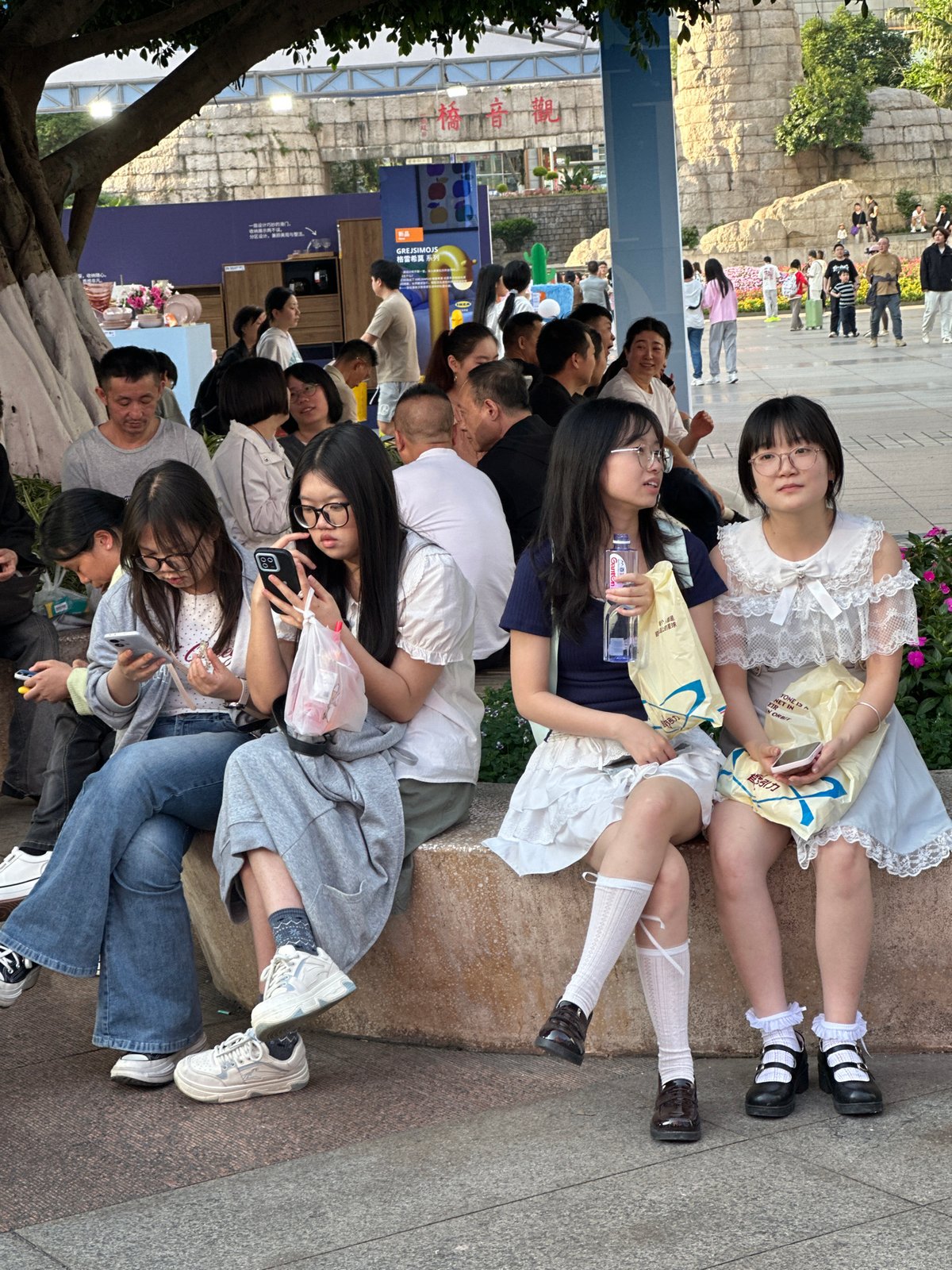 Outdoor gathering with balloon vendor in Liangjiang, China