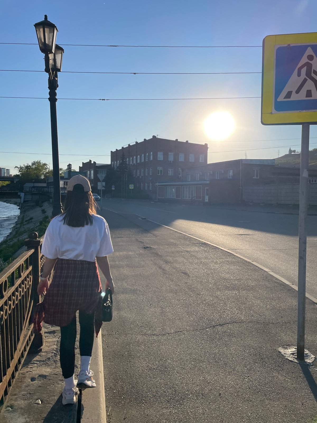Woman photographed at multiple Krasnoyarsk riverside locations during afternoon outing