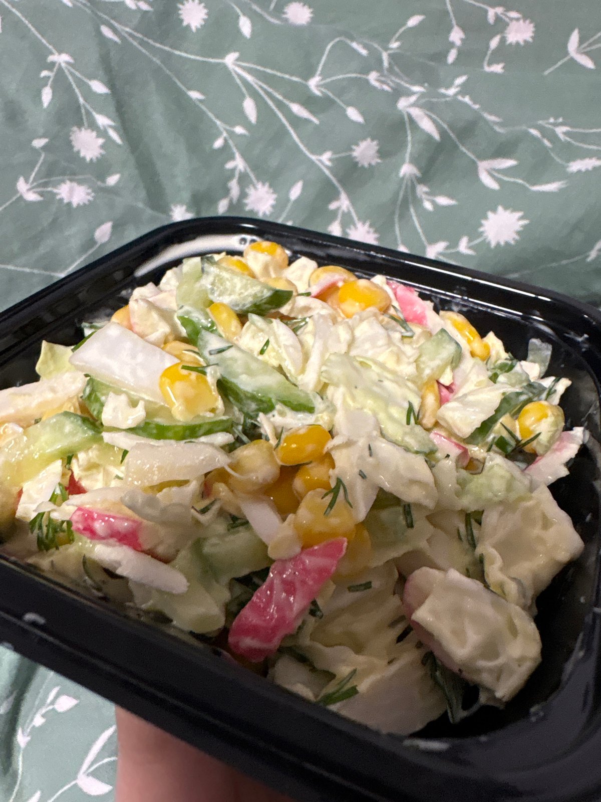 Prepared salad with vegetables and crab meat photographed in Russia