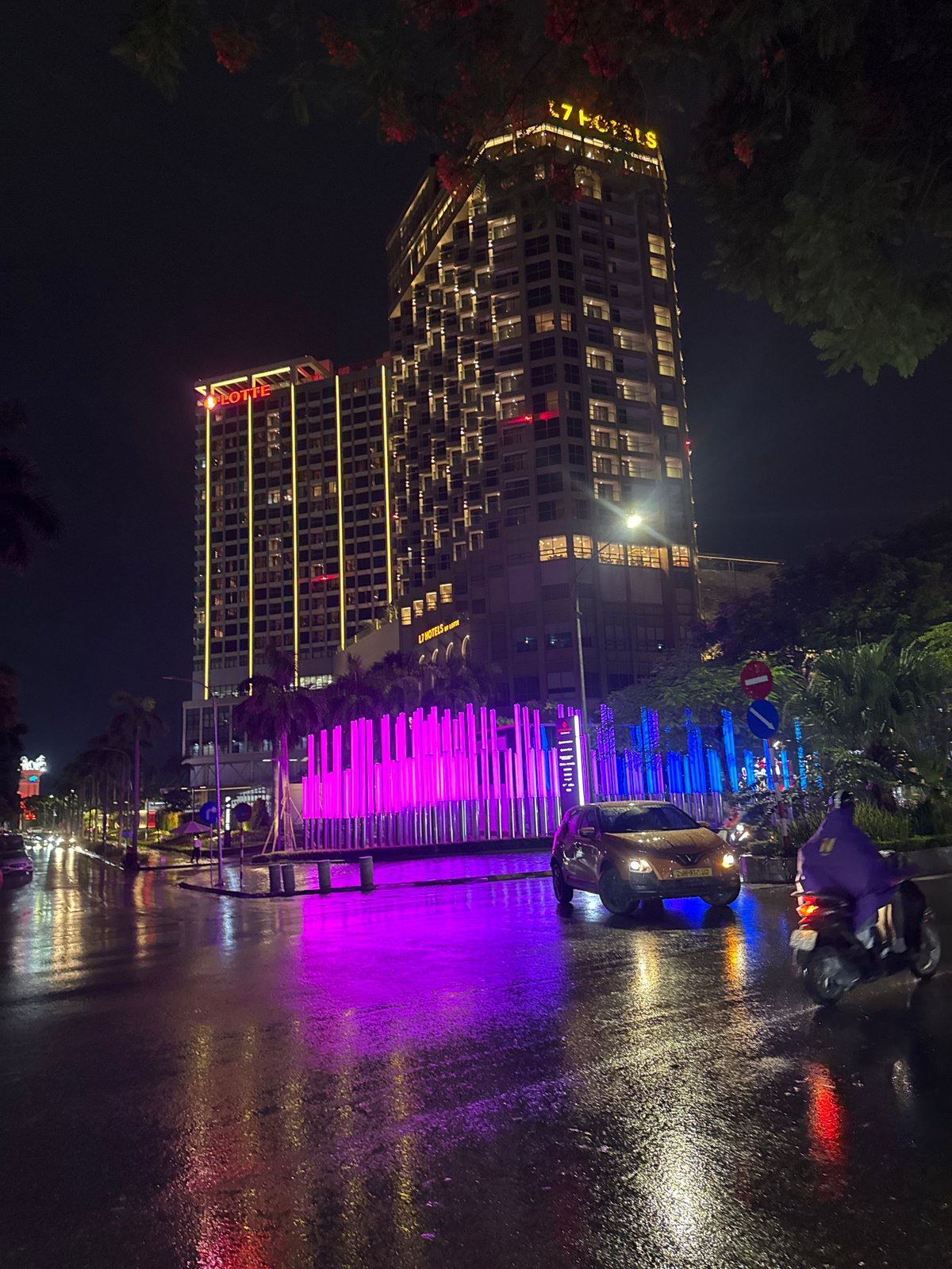 Glowing cylindrical light installation outside Hanoi's Lotte Hotel at night