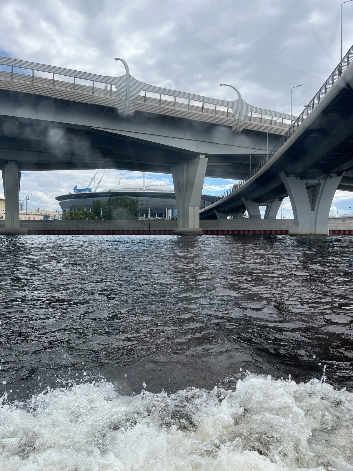Wakeboarding near a stadium and bridge on urban water