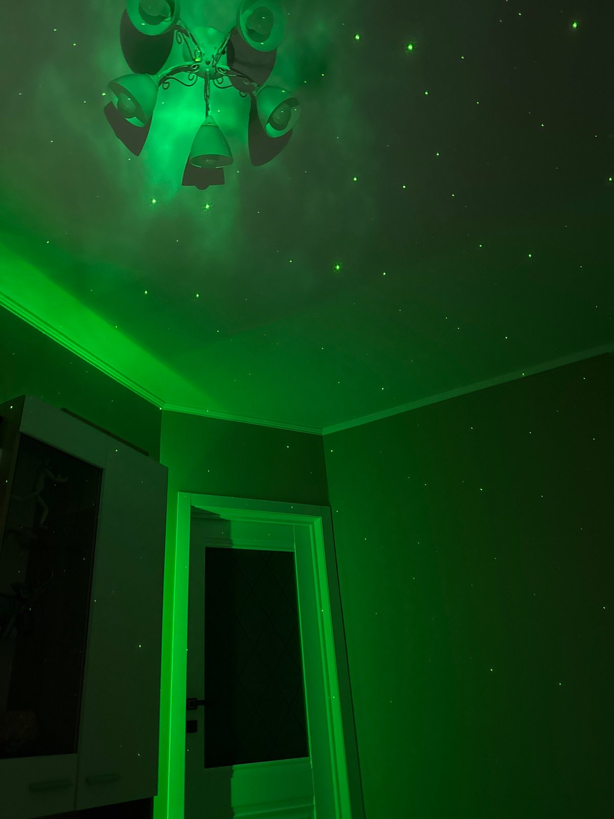 Person watches Russian TV in room with nebula lighting effects