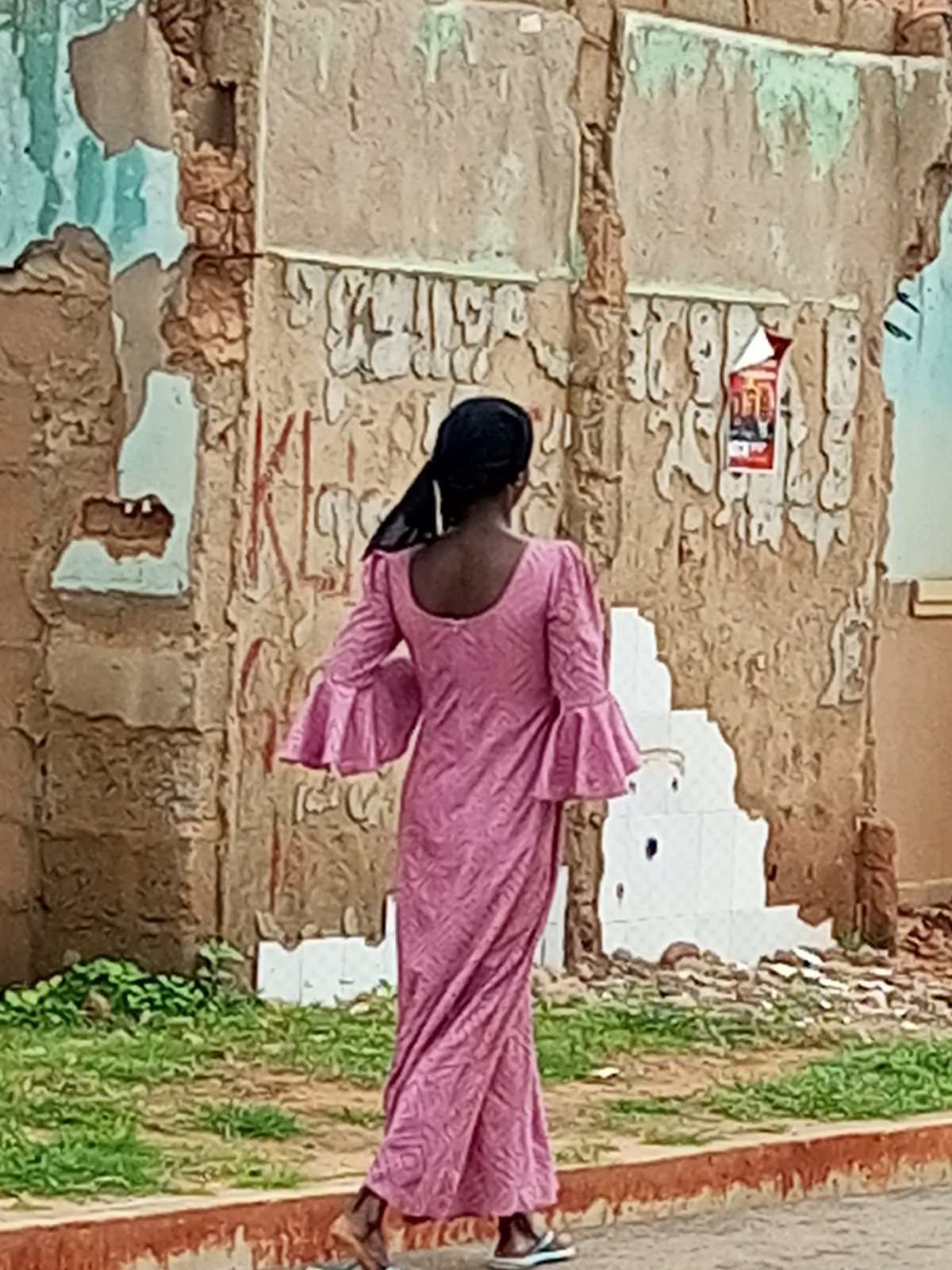 Street scenes: worn building exterior and scooter rider in motion