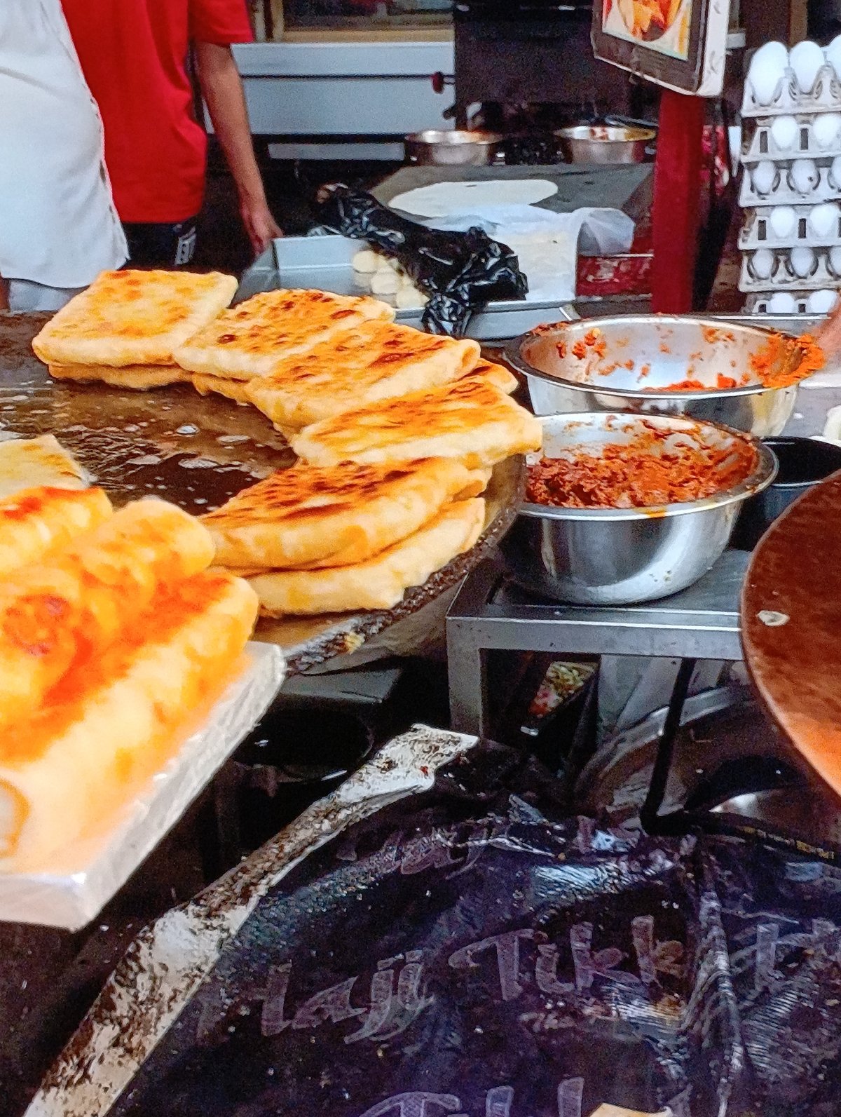 Street food vendor serves customers in busy urban area