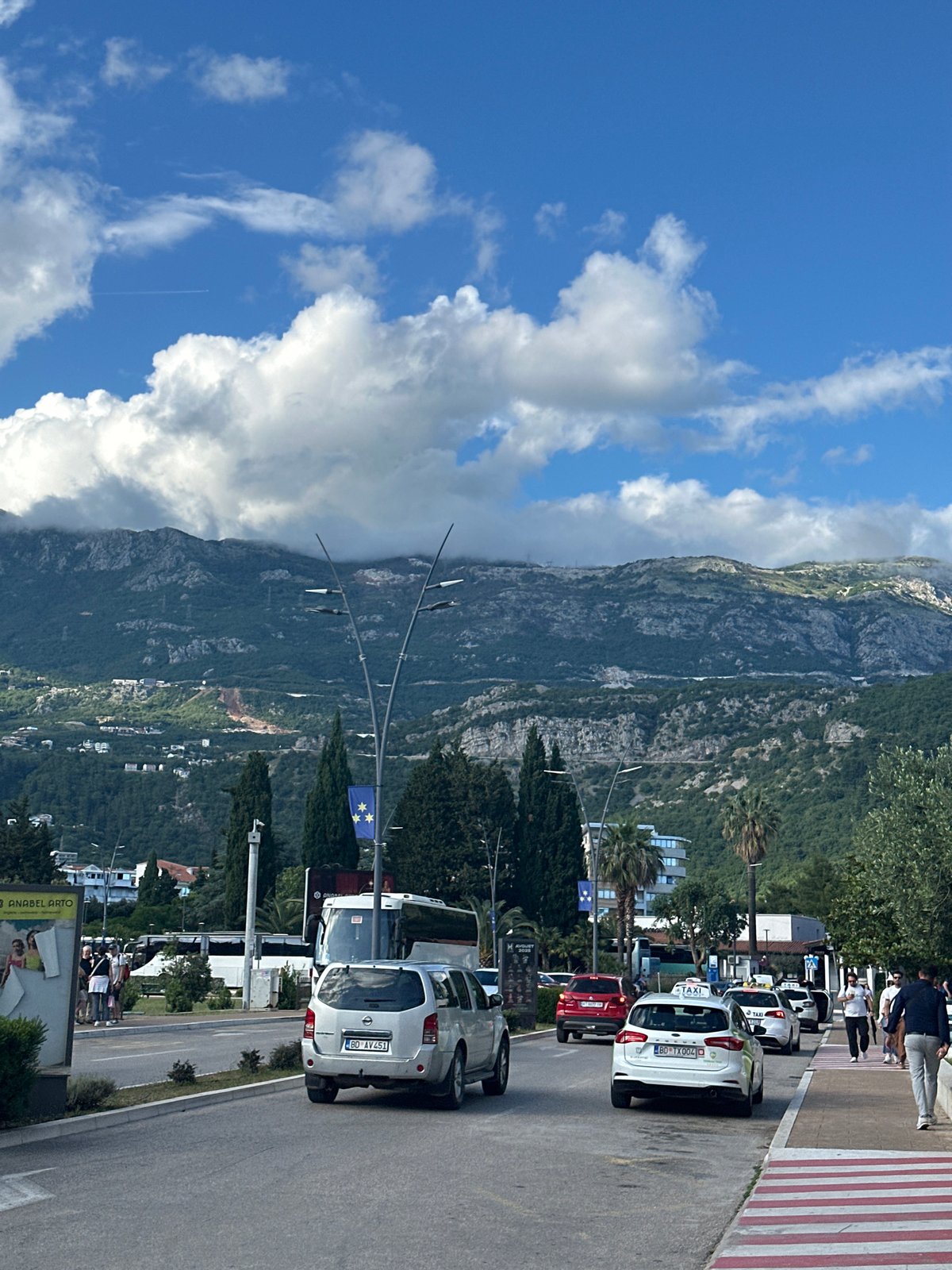 Tourist documents sunny afternoon exploring Budva, Montenegro coastal resort