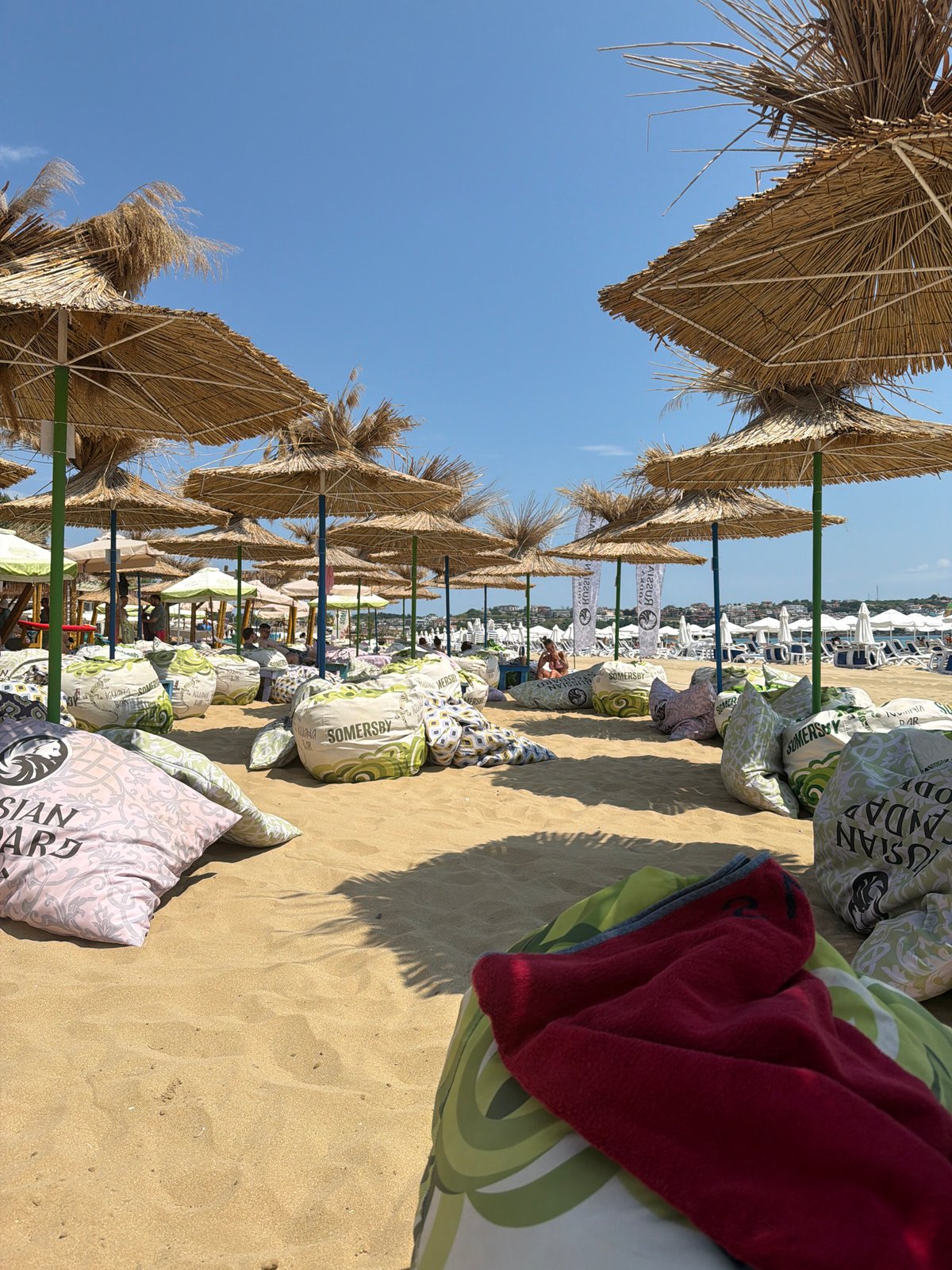 Sozopol beach packed out with beanbag seating on a sunny day
