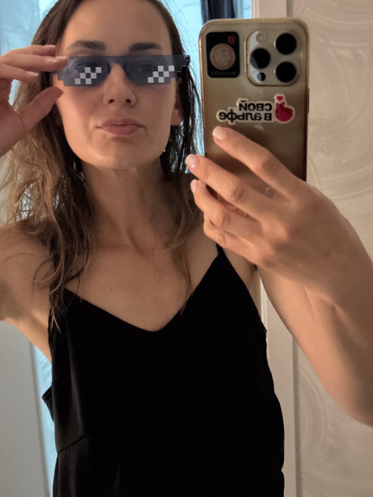 Mirror selfie in Sochi with pixelated shades and a gold phone
