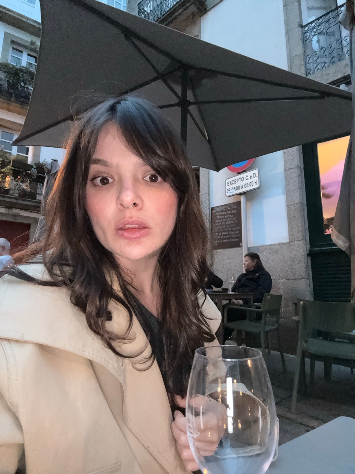 Woman takes selfie at Santiago cafe amid historic architecture