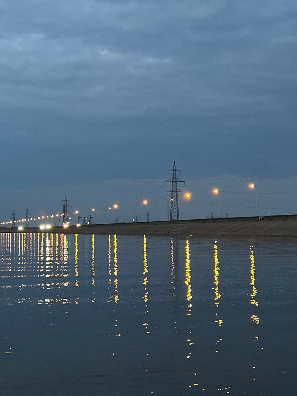 Waterfront evening in Noviy, Russia, Range Rover on sandy shore