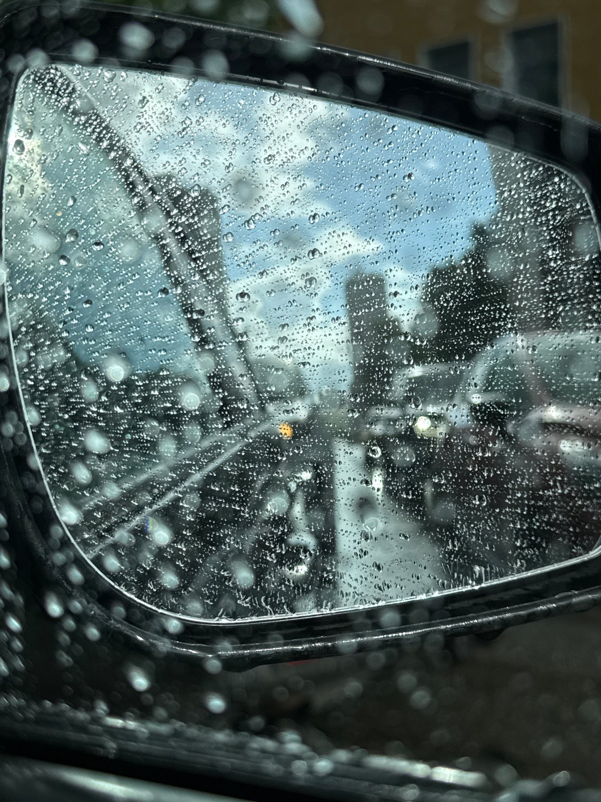 Driving through a rainy Kirov afternoon, streets slick and grey