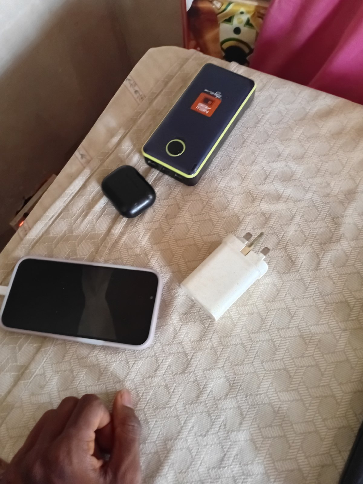 Personal electronics documented on textured surface in Minna
