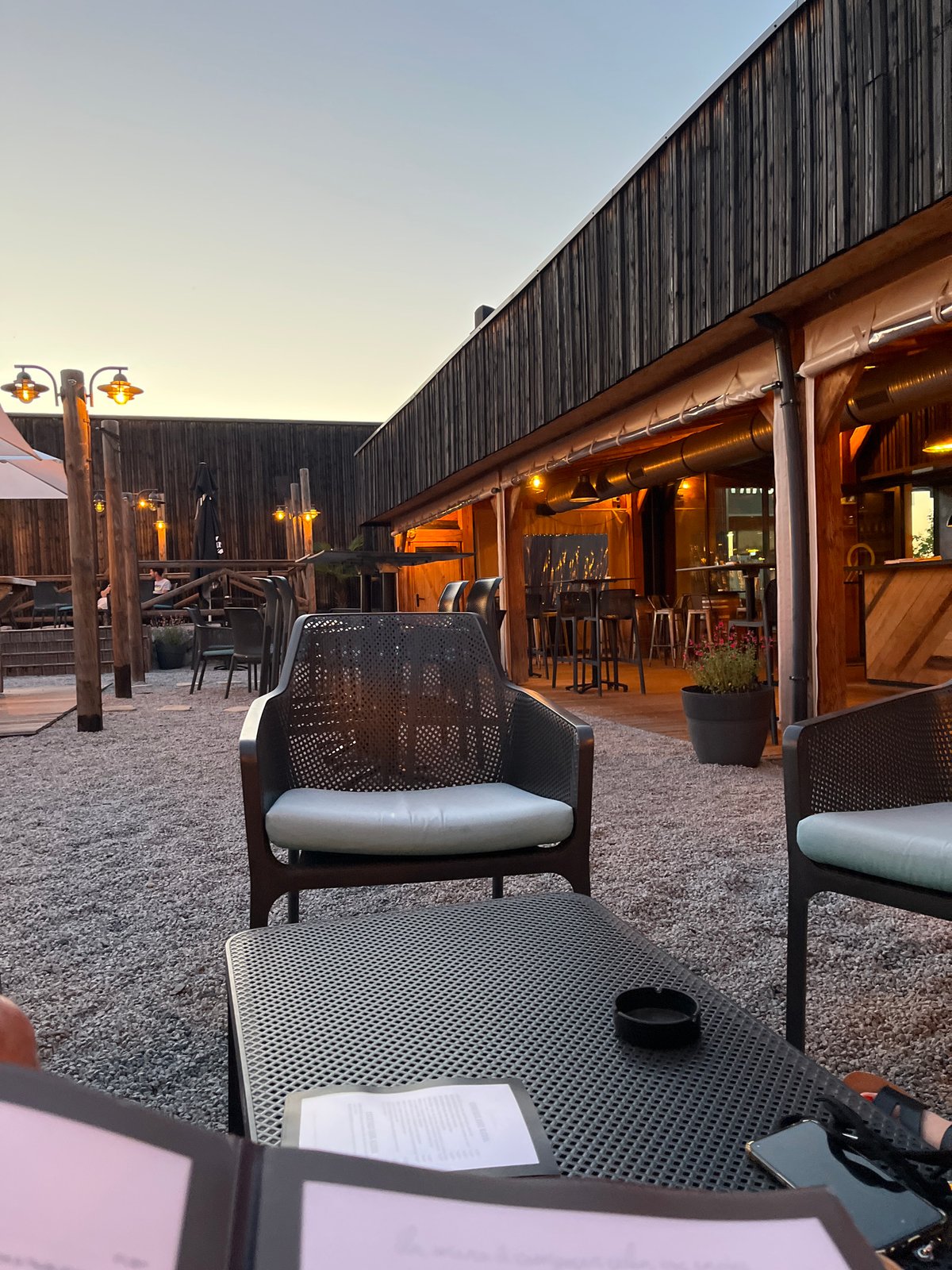 Evening diners gather at outdoor restaurant in Andrézieux-Bouthéon