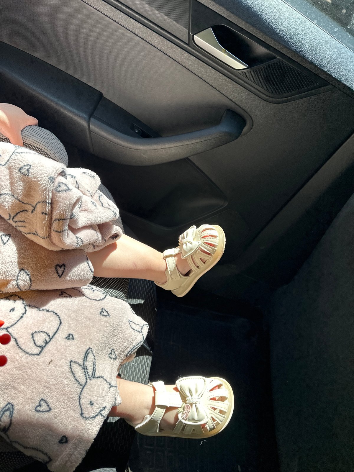 Child rests in car seat during sunny day in Nizhny Novgorod
