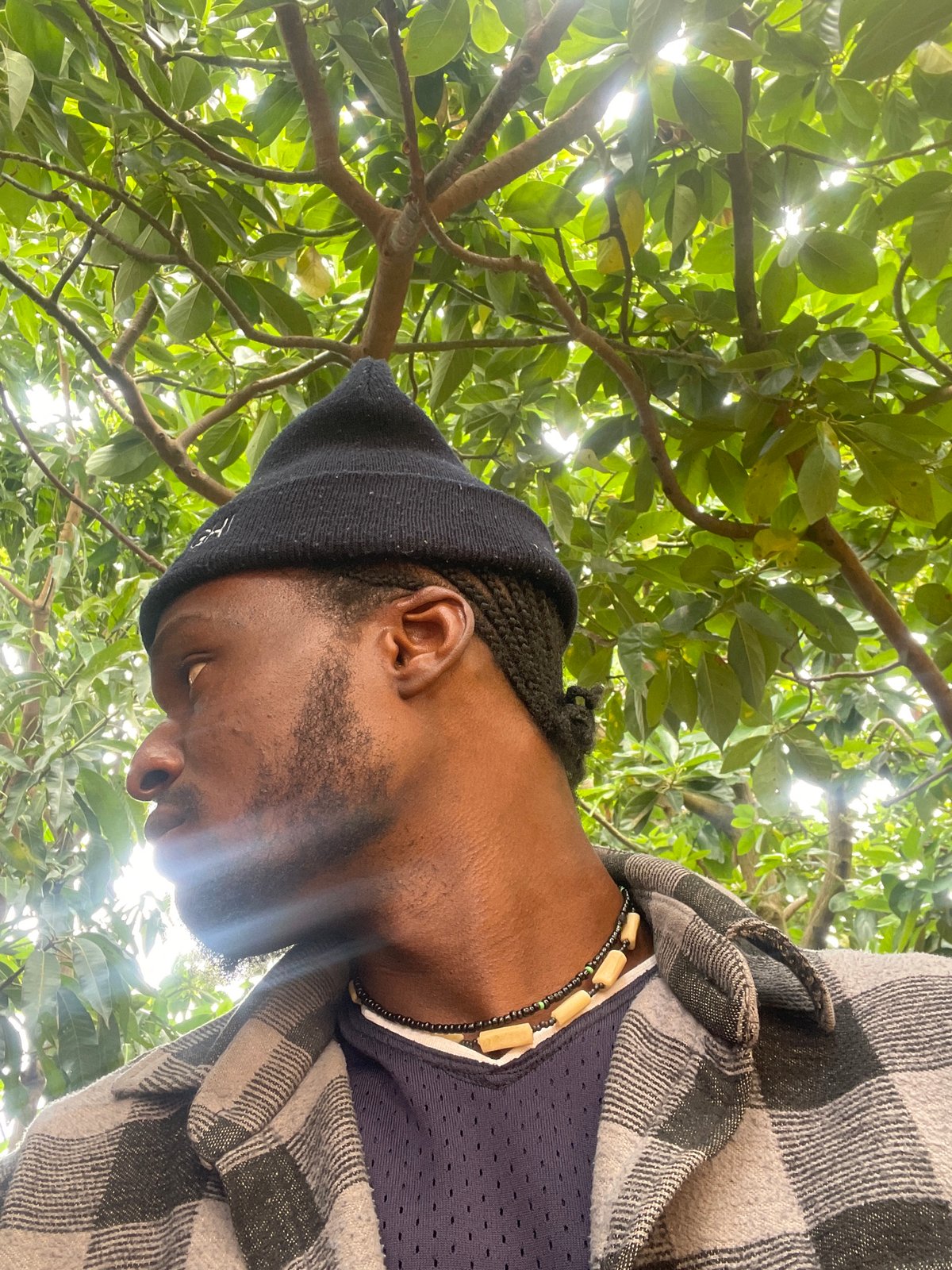 Portrait session beneath tree canopy captured in Jos, Nigeria