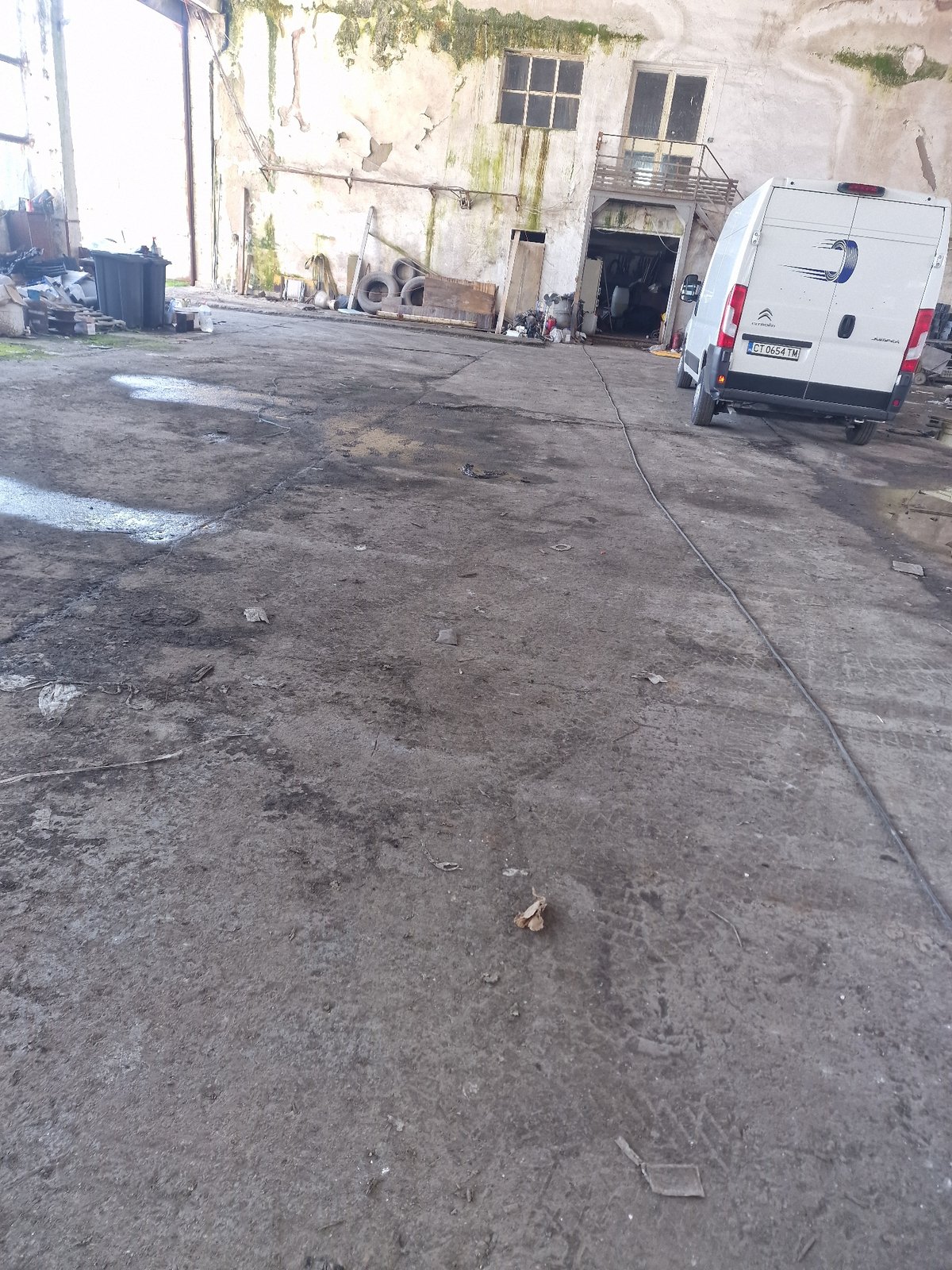 White van with Connecticut plates parked in concrete area