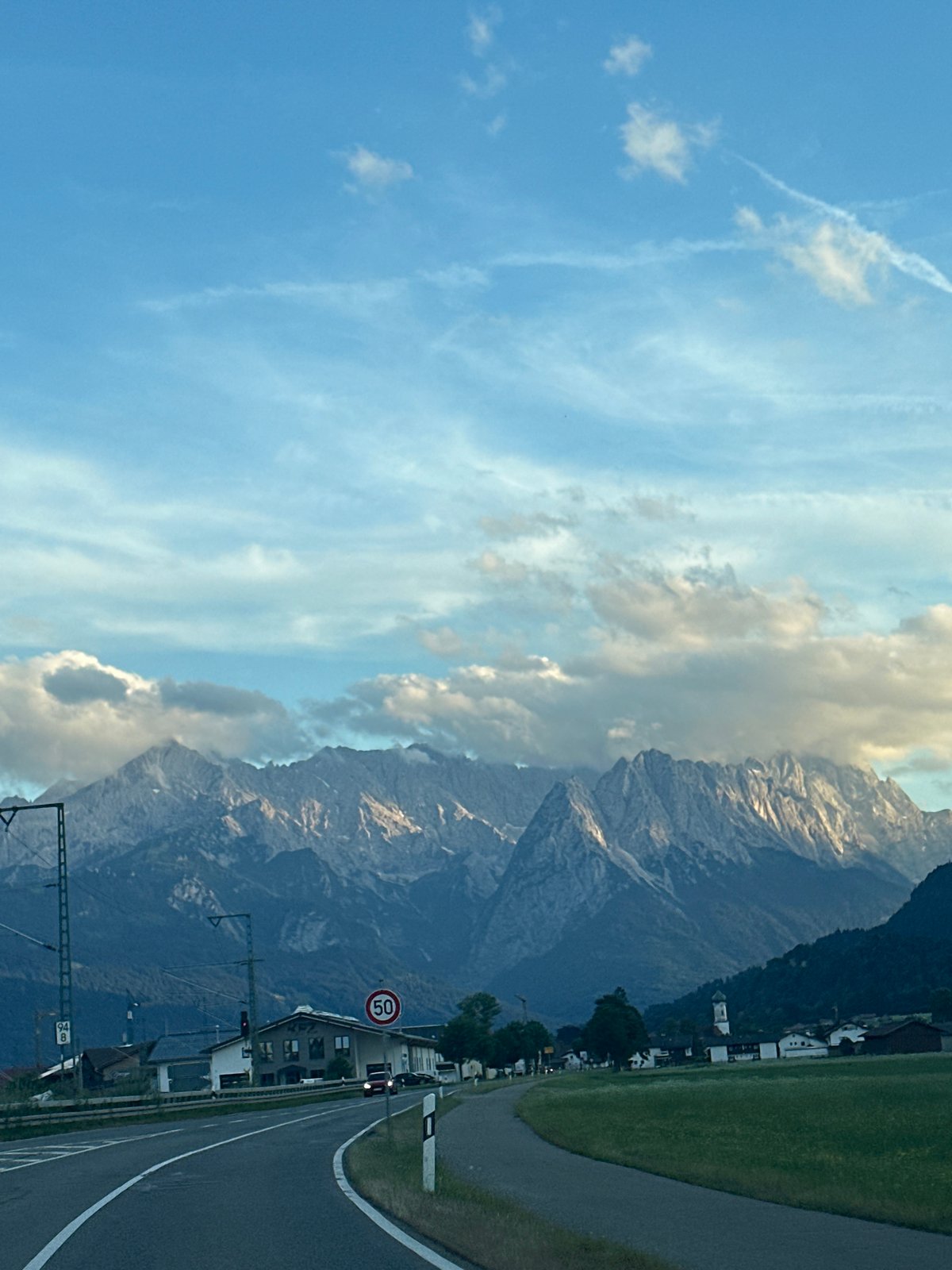 Alpine road through Farchant with mountain views behind the village