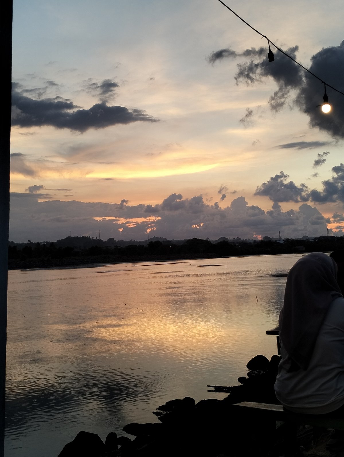 Evening waterfront leisure captured in Lhokseumawe, Indonesia