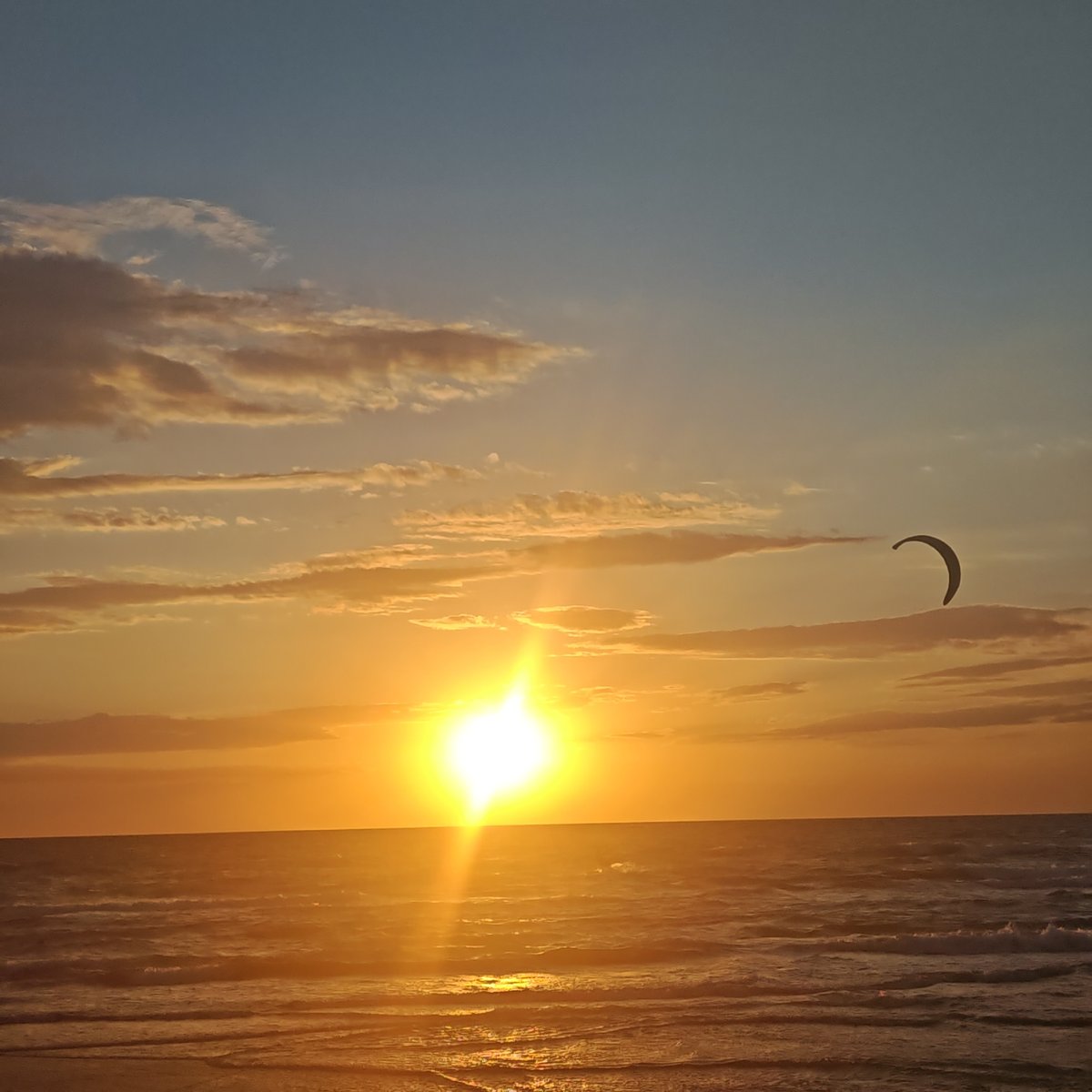 Sunset observed over sea in Shchelkino with kites flying