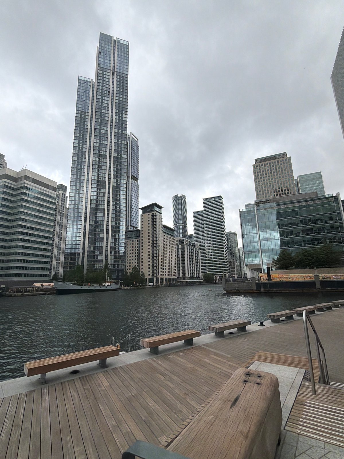 London waterfront morning walk captures luxury yacht, modern skyline