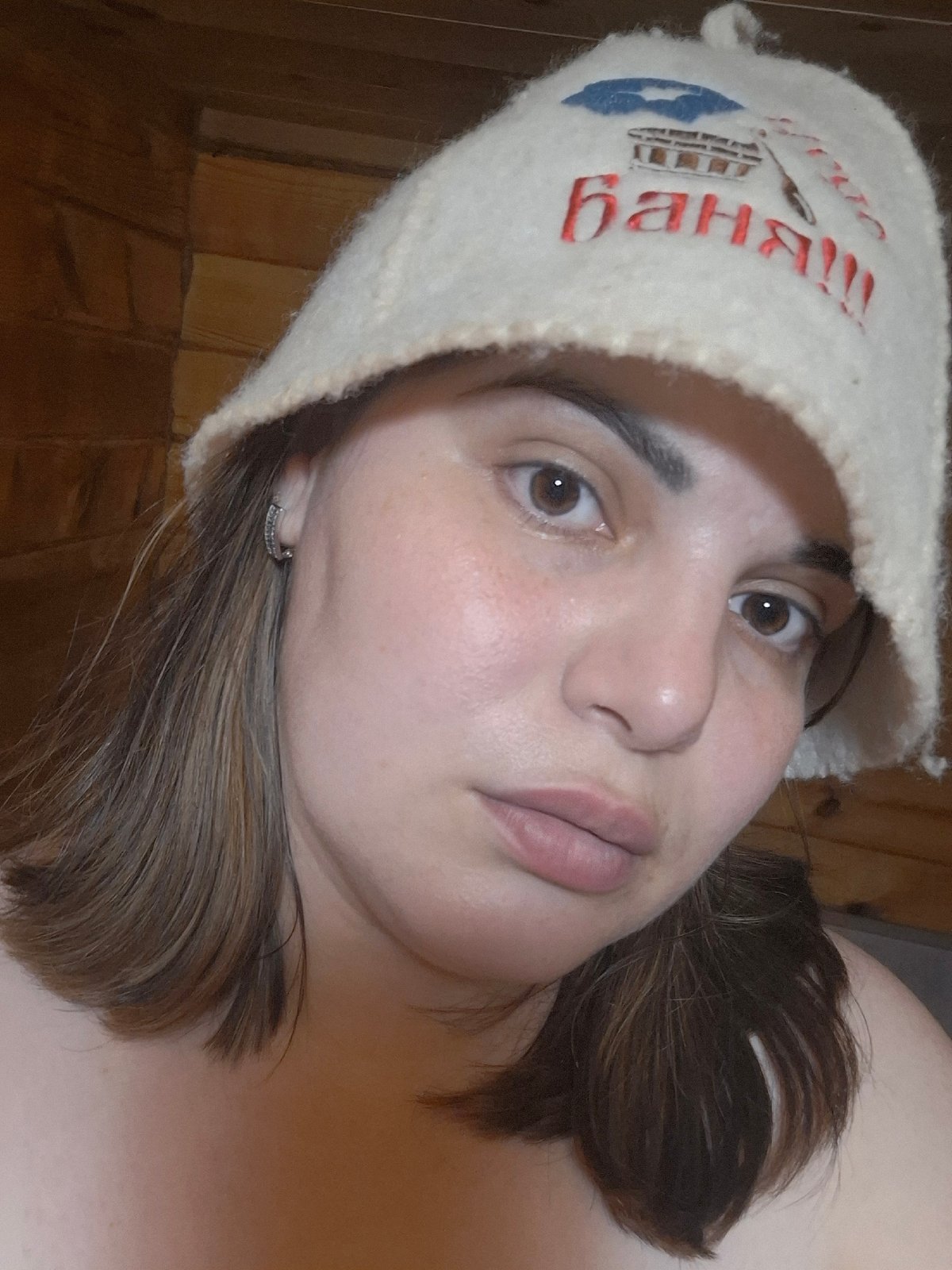 Woman in traditional sauna hat photographed at Russian banya